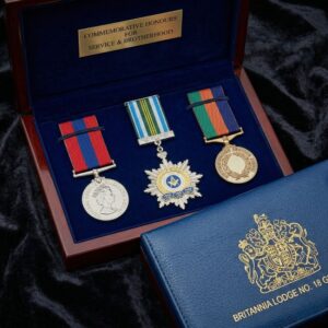Britannia Lodge No. 18 commemorative honors set with masonic service medals in a blue velvet-lined box.