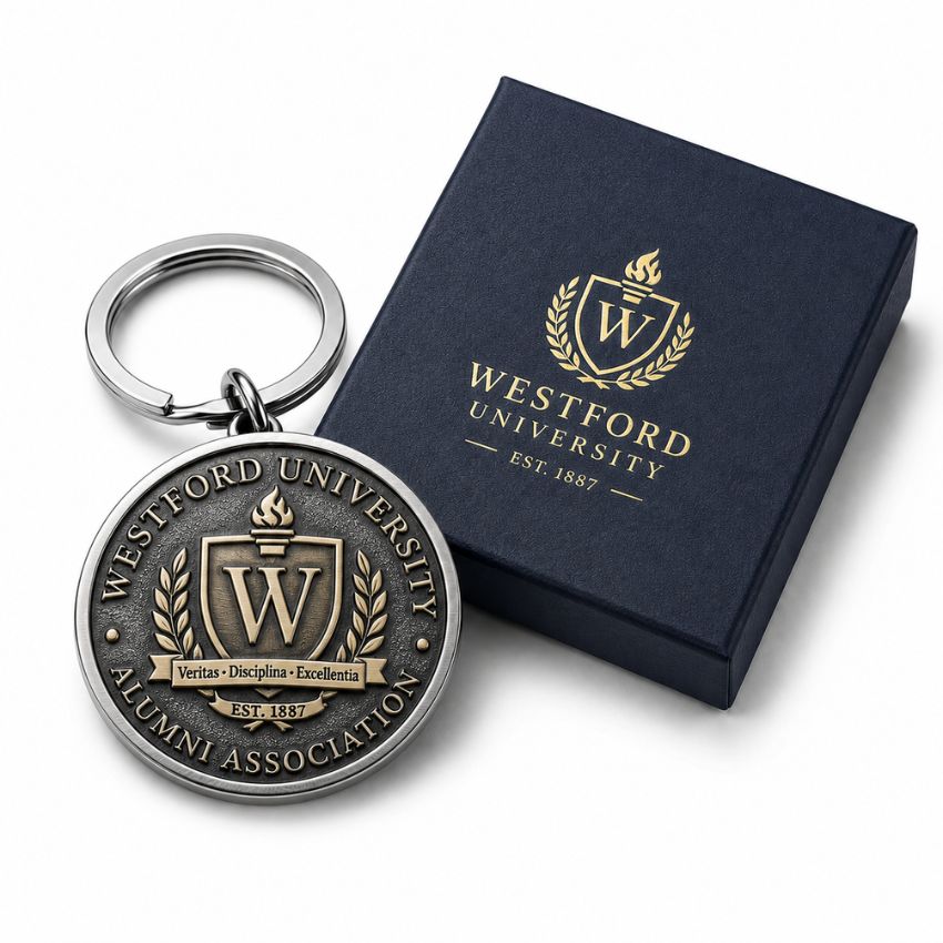 Custom Westford University alumni association round metal keychain with elegant navy blue gift box.