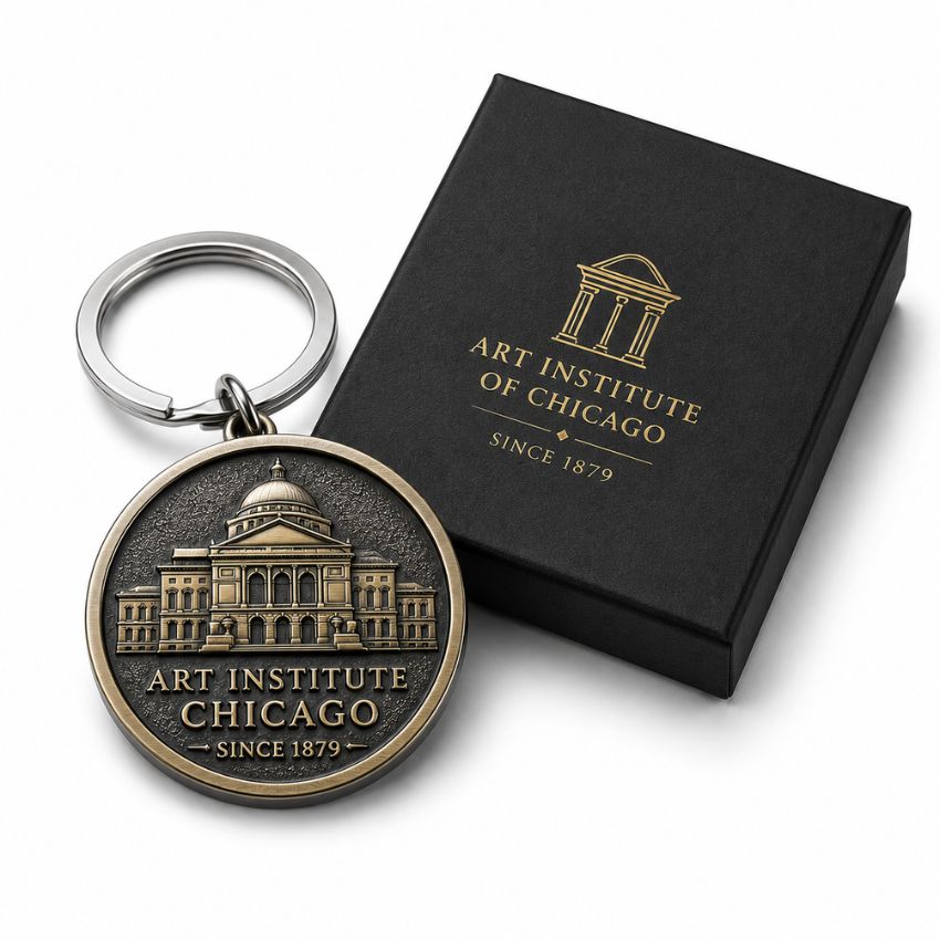 Custom Art Institute of Chicago architectural metal keychain next to a hot stamped black gift box.