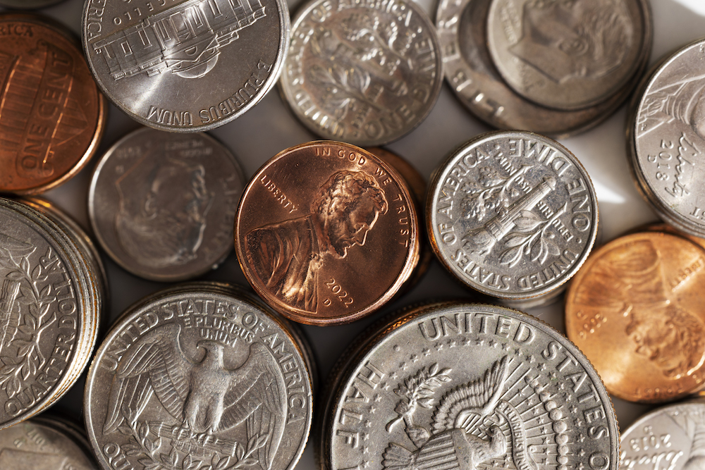 Several coins from the United States spread out on a table.