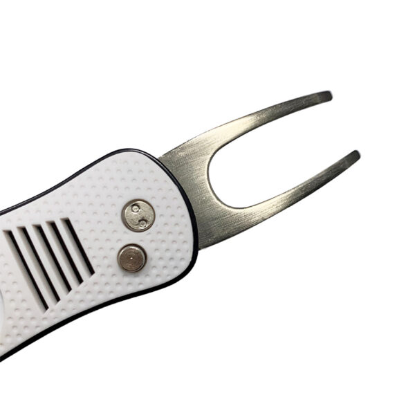 a white foldable divot tool