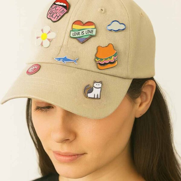 a girl wearing a white hat many custom hat enamel pins