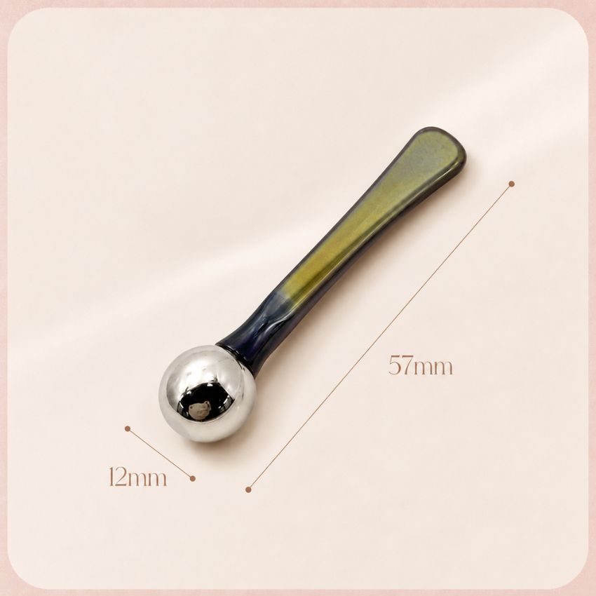 Modern two-tone metal eye roller massager, 57mm aesthetic applicator for targeted skincare routines.
