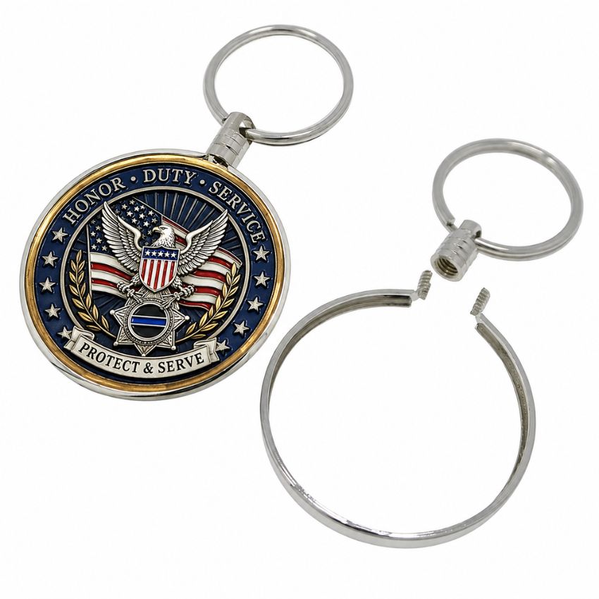 Silver military challenge coin keychain frame with a screw closure system alongside a custom honor duty service coin.