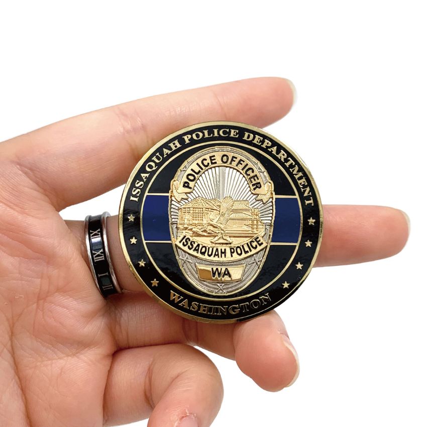 Hand holding a high-quality custom law enforcement badge challenge coin to show scale and finish.