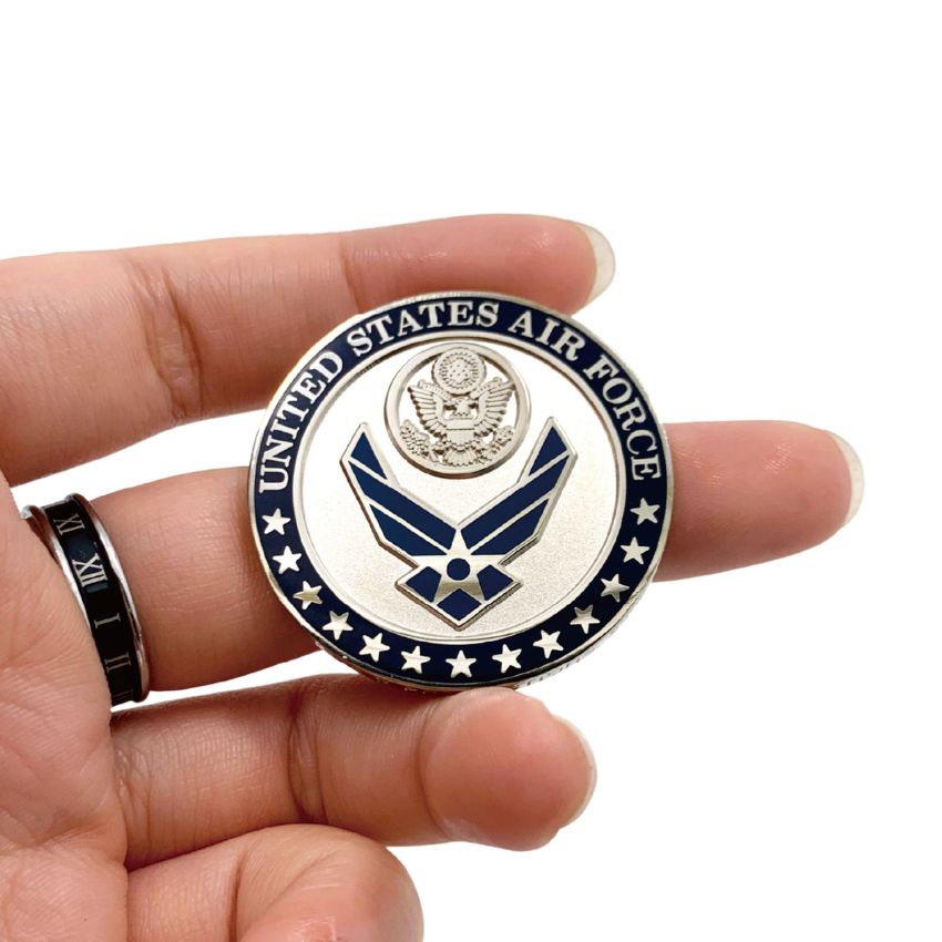 Close-up of premium custom United States Air Force official logo challenge coin held in hand, showing high quality metal.
