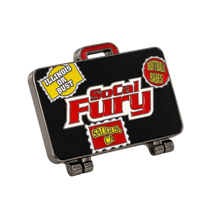 Custom black suitcase-shaped hinged enamel pin featuring SoCal Fury softball team branding and travel stickers.