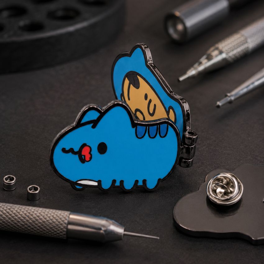 Custom interactive blue character hinged enamel pin with metal engraving tools, ideal for OEM badge manufacturing.