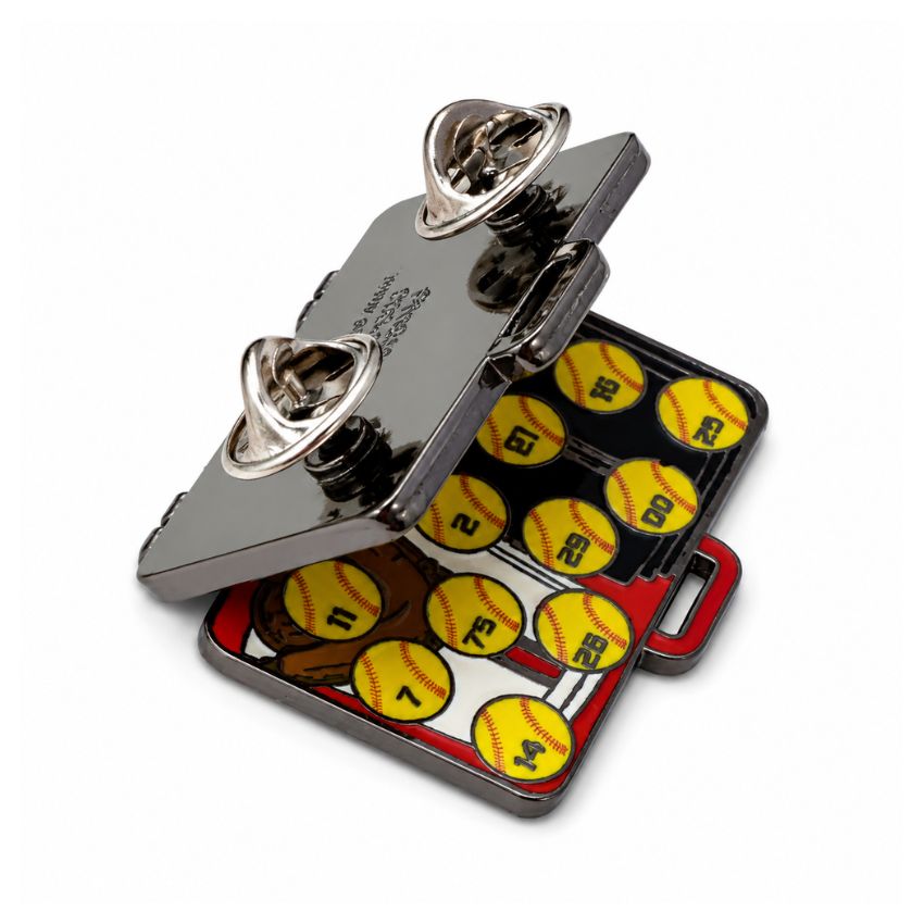Custom opening hinged enamel pin demonstrating outer suitcase design and interior softball championship graphics.