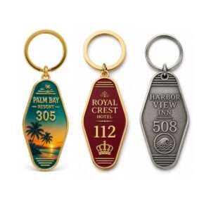 Assorted custom vintage metal motel keychains with engraved hotel room numbers for hospitality branding merchandise.