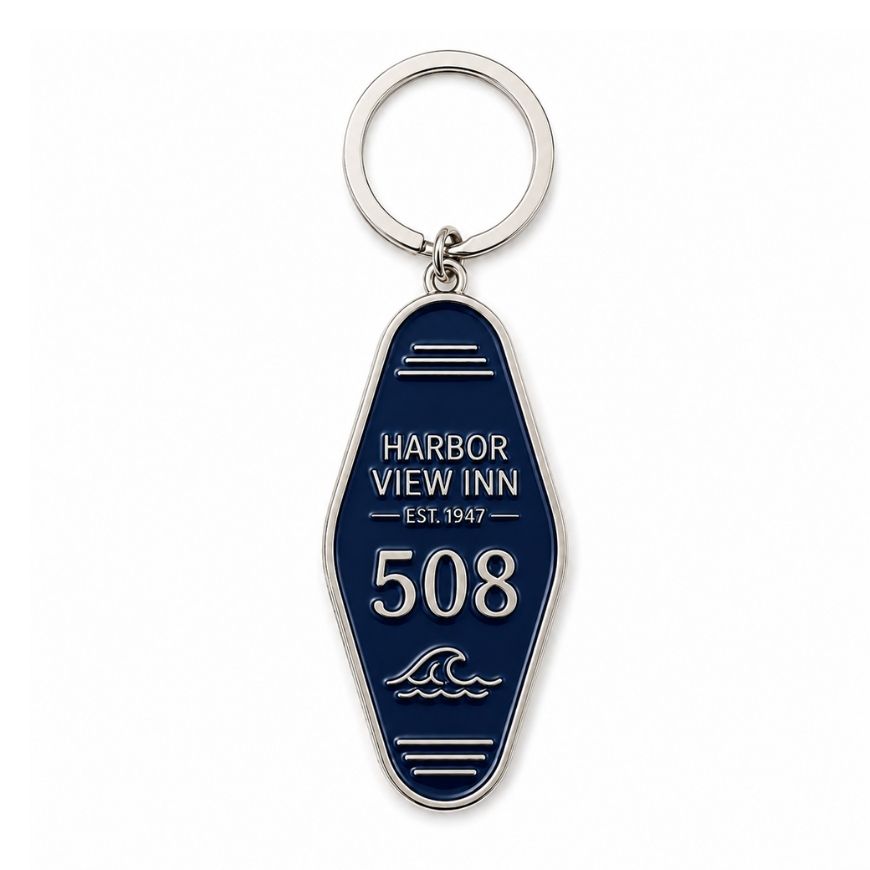 Custom dark blue enamel motel key tag featuring silver wave emblem, ideal for coastal resort custom merchandise.