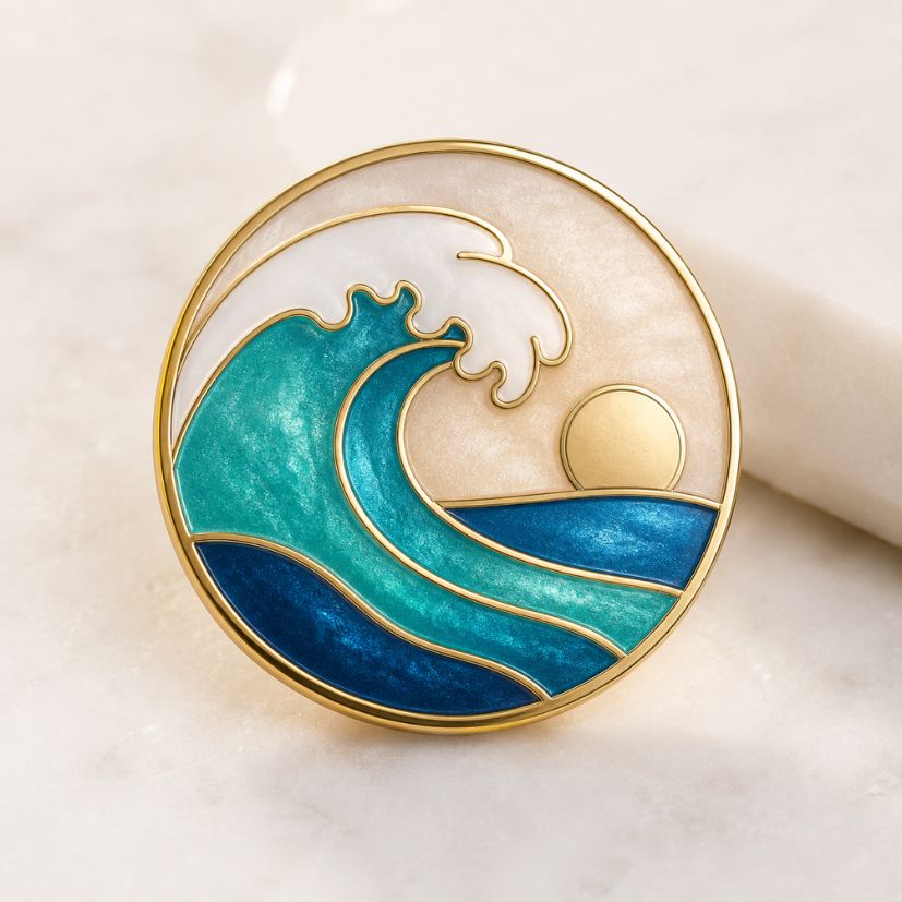 Ocean wave and sun enamel pin with marbled resin and gold trim, custom badge.